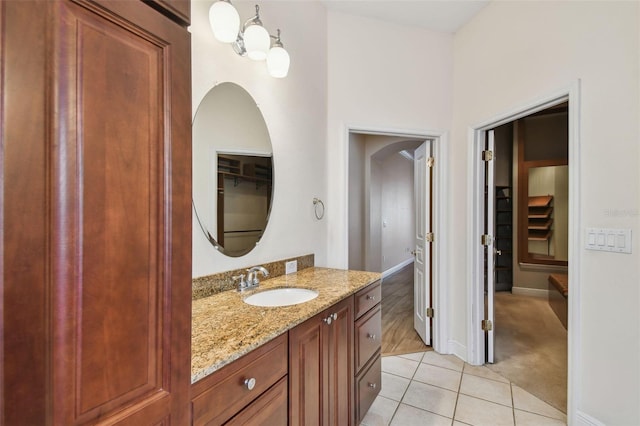 bathroom with baseboards, vanity, and tile patterned floors