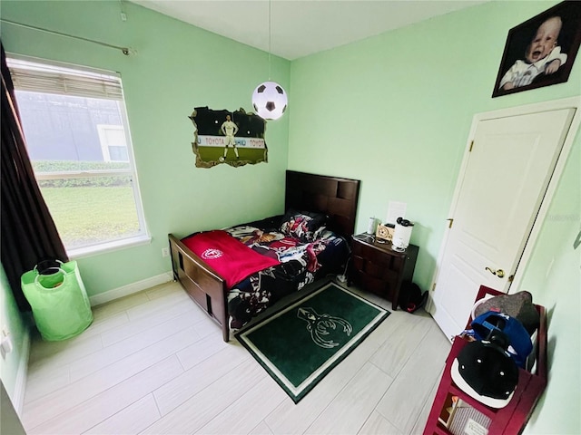 bedroom featuring multiple windows and baseboards