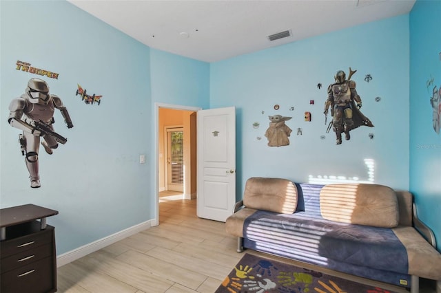 sitting room featuring light wood-style floors, baseboards, and visible vents