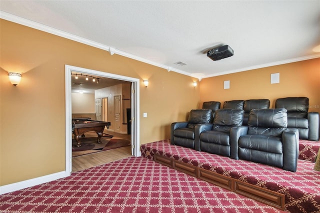 cinema with baseboards, visible vents, crown molding, and wood finished floors