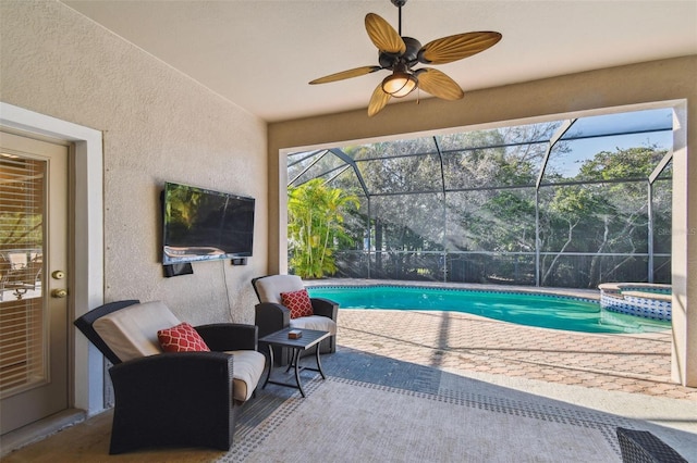 view of swimming pool featuring a lanai, a patio area, ceiling fan, and a pool with connected hot tub