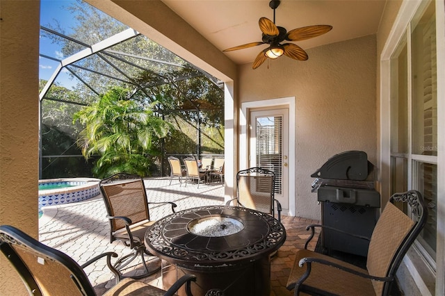 view of patio / terrace featuring a lanai, ceiling fan, and outdoor dining area