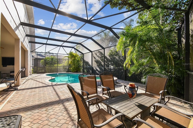 outdoor pool featuring a patio area and glass enclosure