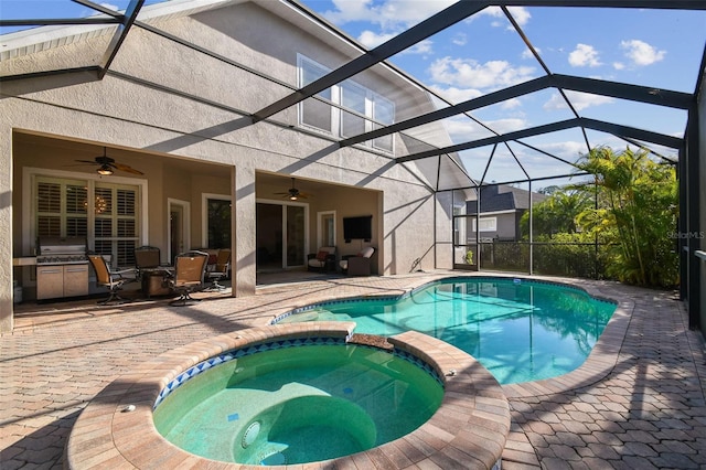 view of pool with ceiling fan, glass enclosure, a patio area, and a pool with connected hot tub