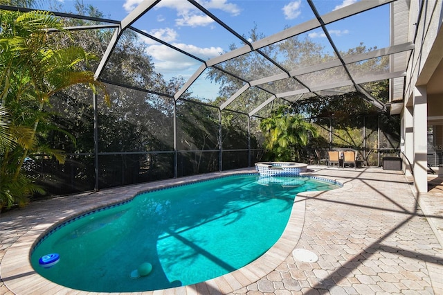 view of swimming pool with a lanai, a patio area, and a pool with connected hot tub