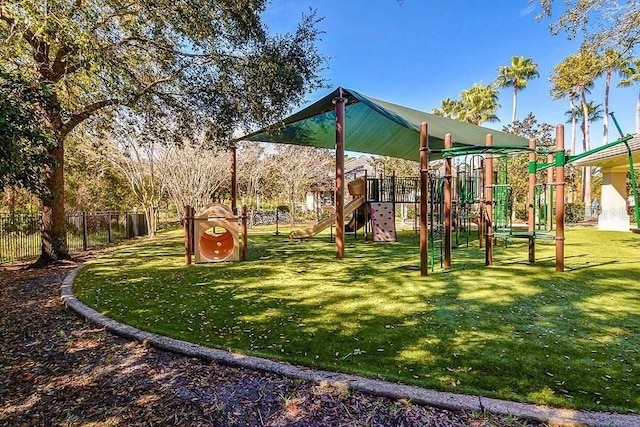 communal playground with fence and a lawn