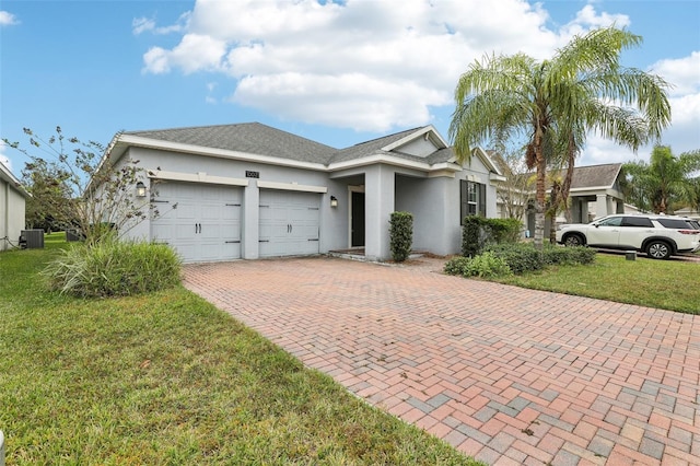 single story home with central air condition unit, a front lawn, and a garage