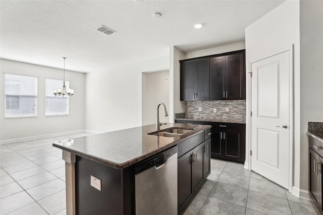 kitchen with dishwasher, sink, an inviting chandelier, decorative backsplash, and a center island with sink