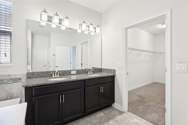 bathroom featuring tile patterned flooring, vanity, and a healthy amount of sunlight