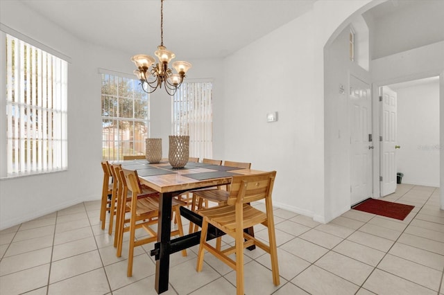 tiled dining area with a notable chandelier