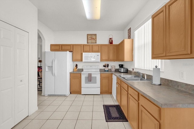 kitchen featuring white appliances, light tile patterned floors, and sink