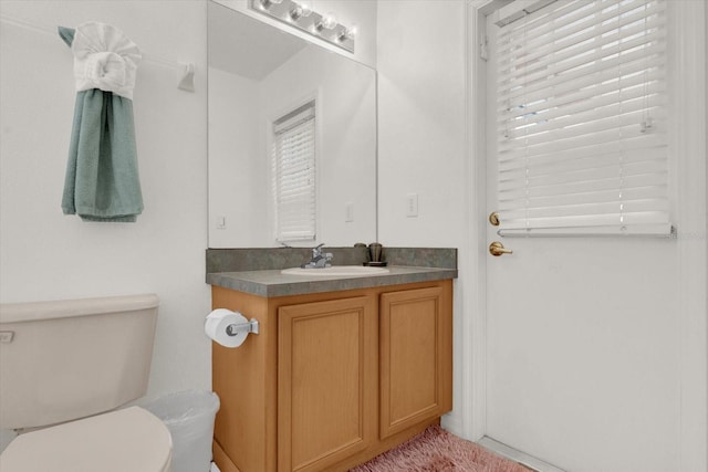 bathroom with toilet and vanity