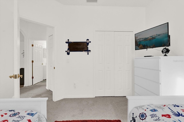 carpeted bedroom featuring a closet