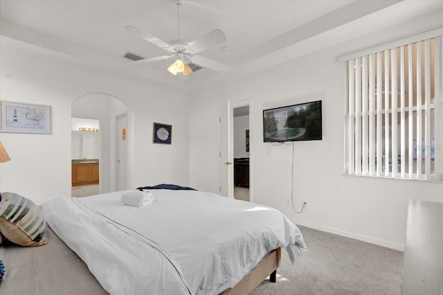 carpeted bedroom featuring connected bathroom and ceiling fan