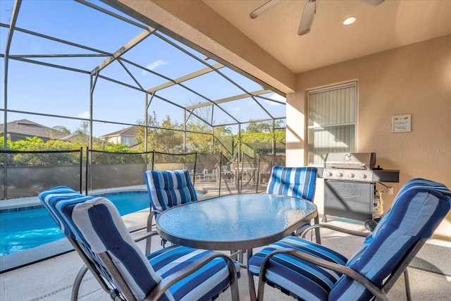 view of patio featuring a grill, glass enclosure, and ceiling fan