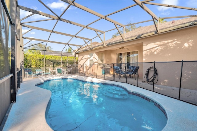 view of pool with a patio, ceiling fan, and a lanai