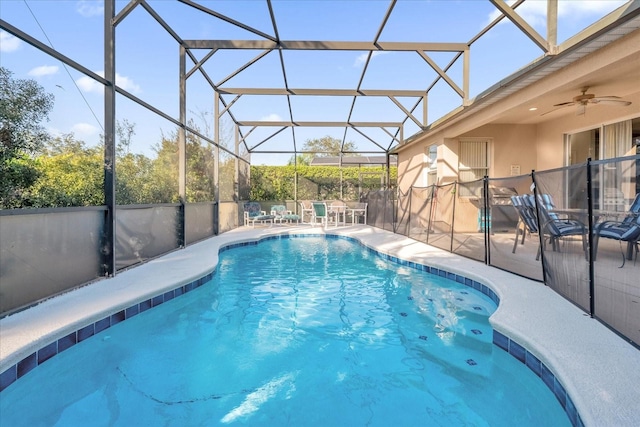 view of swimming pool featuring a patio area, a lanai, and ceiling fan