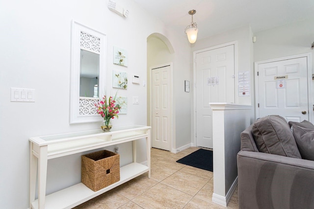 tiled entryway with lofted ceiling