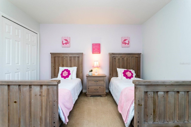 bedroom featuring a closet and light colored carpet