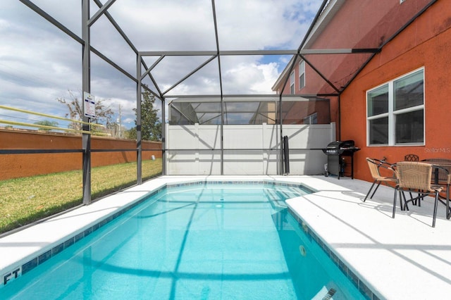 view of swimming pool with a patio area, grilling area, and glass enclosure