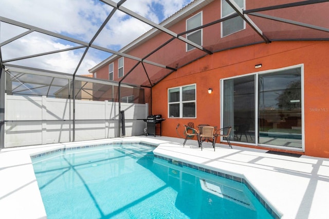 view of swimming pool featuring a patio, a lanai, and grilling area