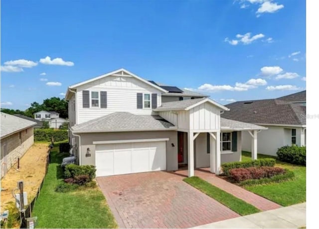 view of front of home featuring a garage and a front lawn