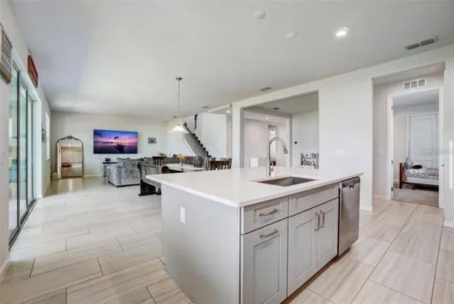 kitchen with sink, a wealth of natural light, a center island with sink, and dishwasher