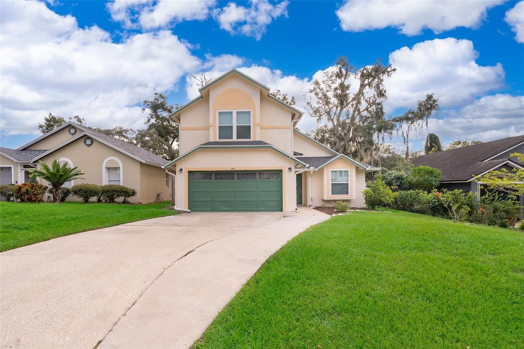 view of property with a front yard and a garage