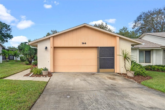 view of front of property with a front yard and a garage