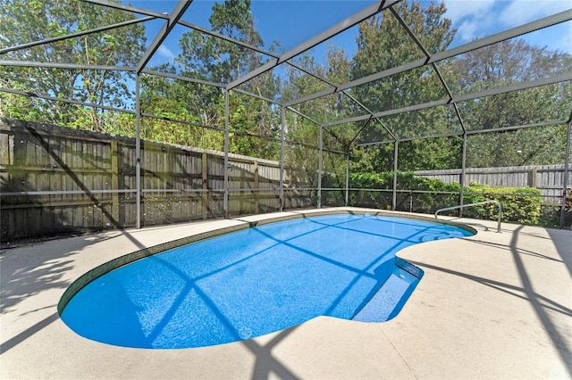 view of pool featuring a patio and glass enclosure