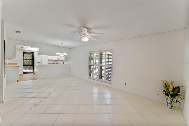 interior space featuring a textured ceiling, light tile patterned floors, and ceiling fan with notable chandelier