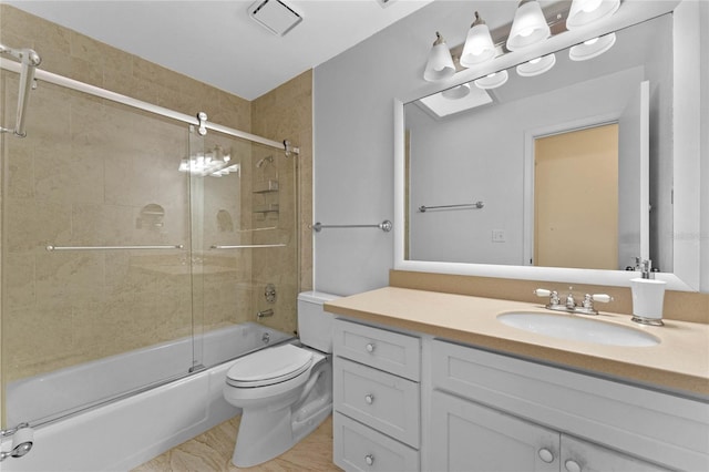 full bathroom featuring toilet, bath / shower combo with glass door, and vanity