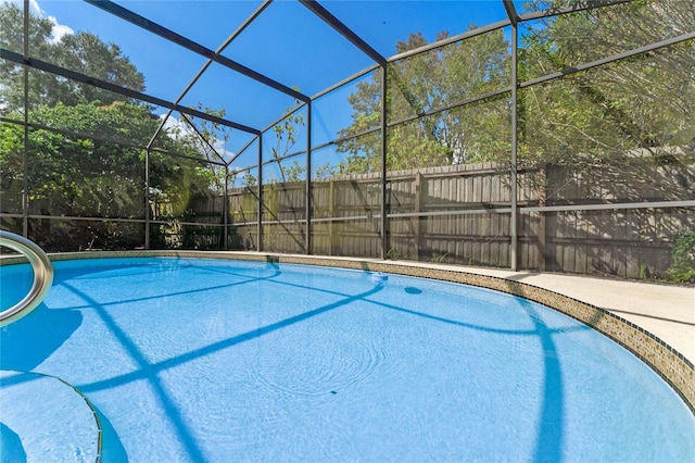 view of swimming pool with glass enclosure