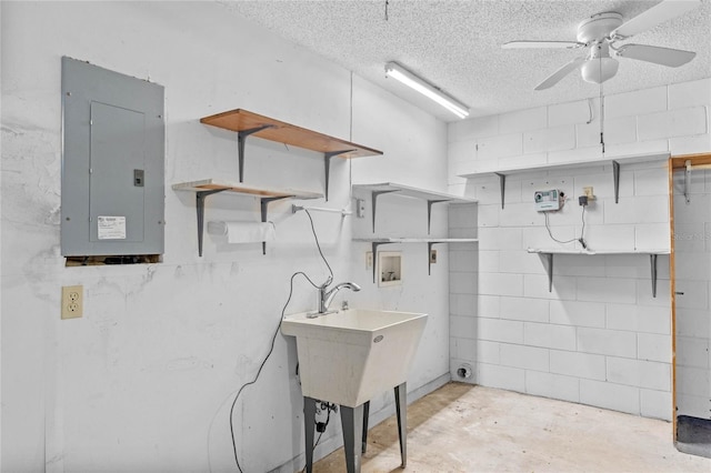 laundry area featuring electric panel, hookup for a washing machine, a textured ceiling, and ceiling fan