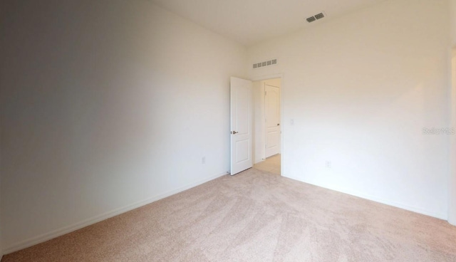 unfurnished room with light carpet