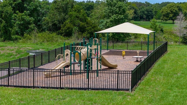 view of jungle gym with a lawn