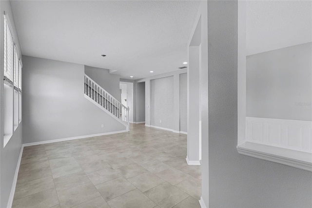 unfurnished living room featuring light tile patterned flooring