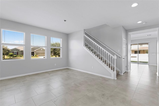 tiled empty room featuring a wealth of natural light