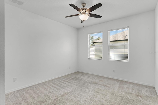 carpeted spare room with ceiling fan