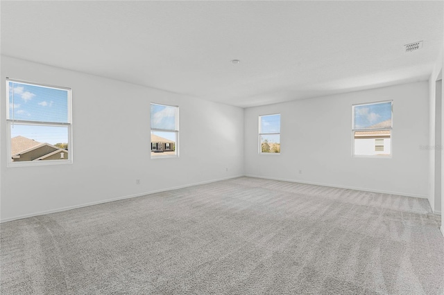 carpeted empty room featuring a healthy amount of sunlight