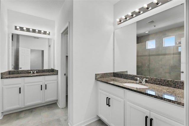 bathroom featuring vanity, tile patterned flooring, and walk in shower