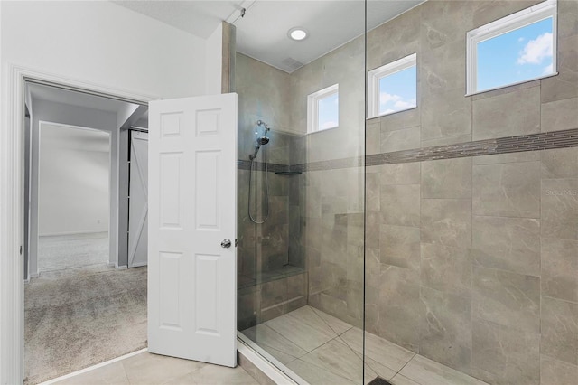 bathroom featuring tiled shower and tile patterned floors