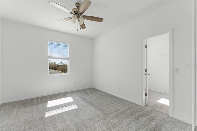 unfurnished room featuring light carpet and ceiling fan