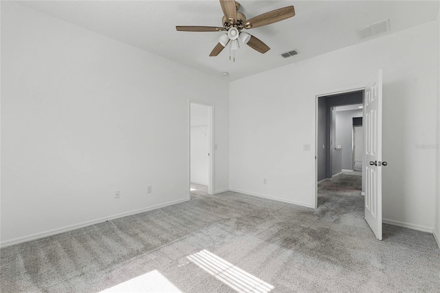 spare room featuring light carpet and ceiling fan