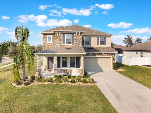 view of front of house with a garage, a front yard, and a porch