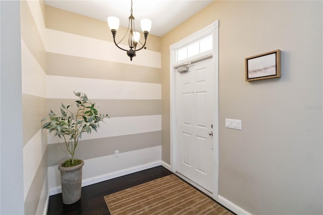 foyer entrance featuring a chandelier and dark hardwood / wood-style flooring