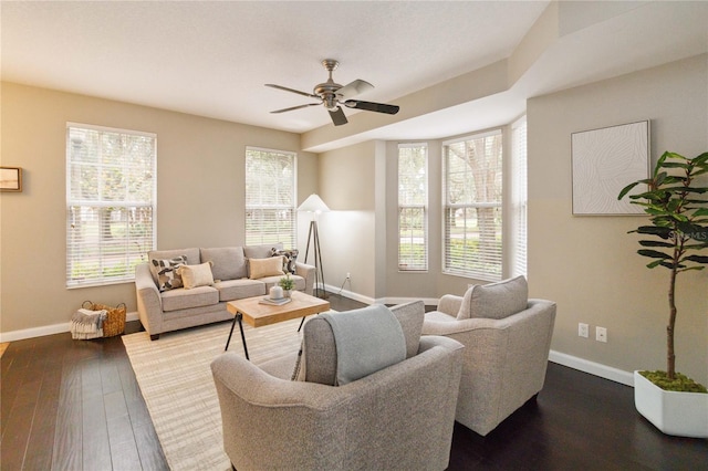 living room featuring wood-type flooring and ceiling fan