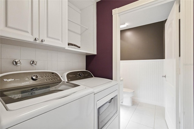 laundry area featuring washer and dryer and light tile patterned floors