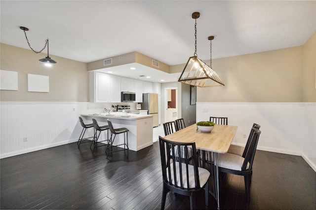 dining space featuring dark hardwood / wood-style floors