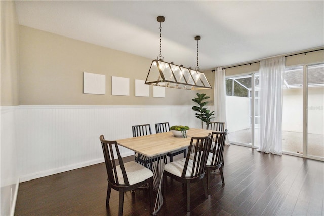 dining space with dark hardwood / wood-style floors